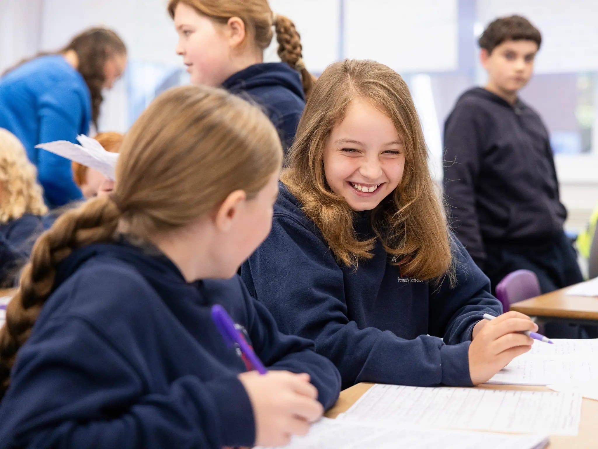 Older pupils laughing together during a lesson