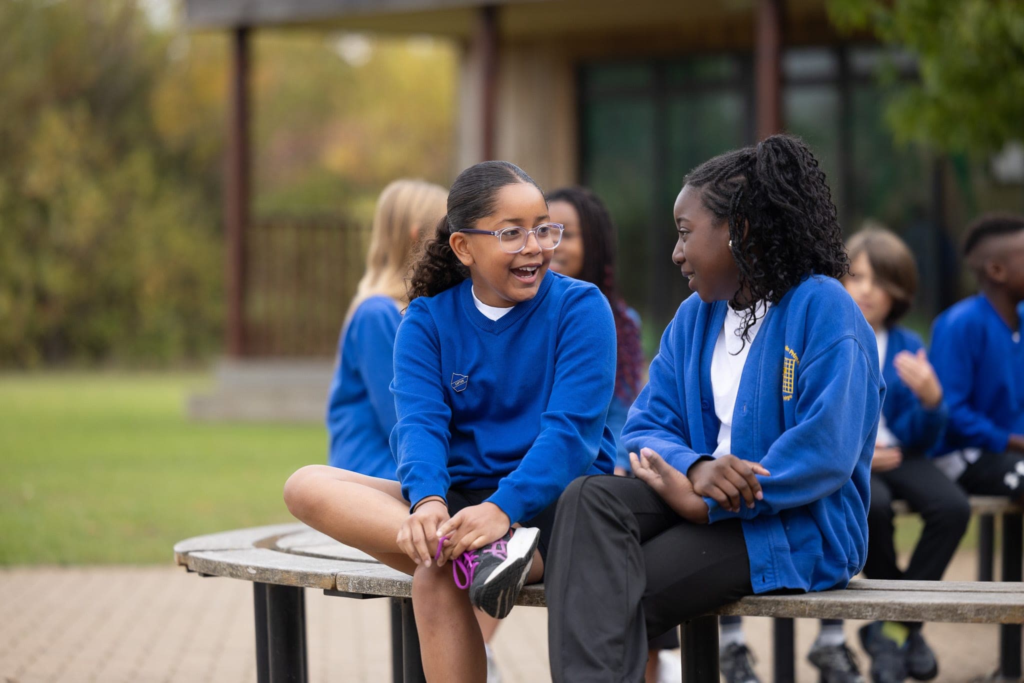 Older pupils chatting and laughing together outside
