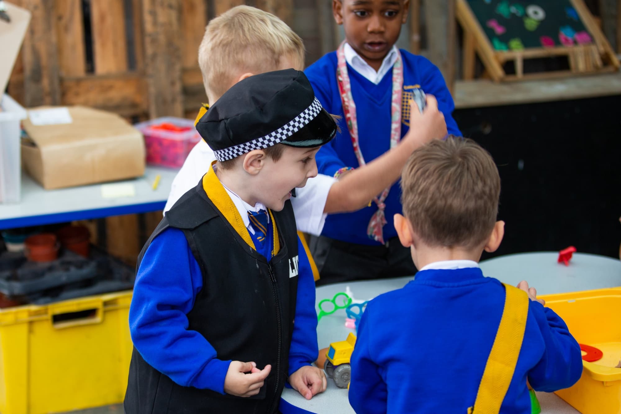 Young pupils dressing up and playing together in a role-play area