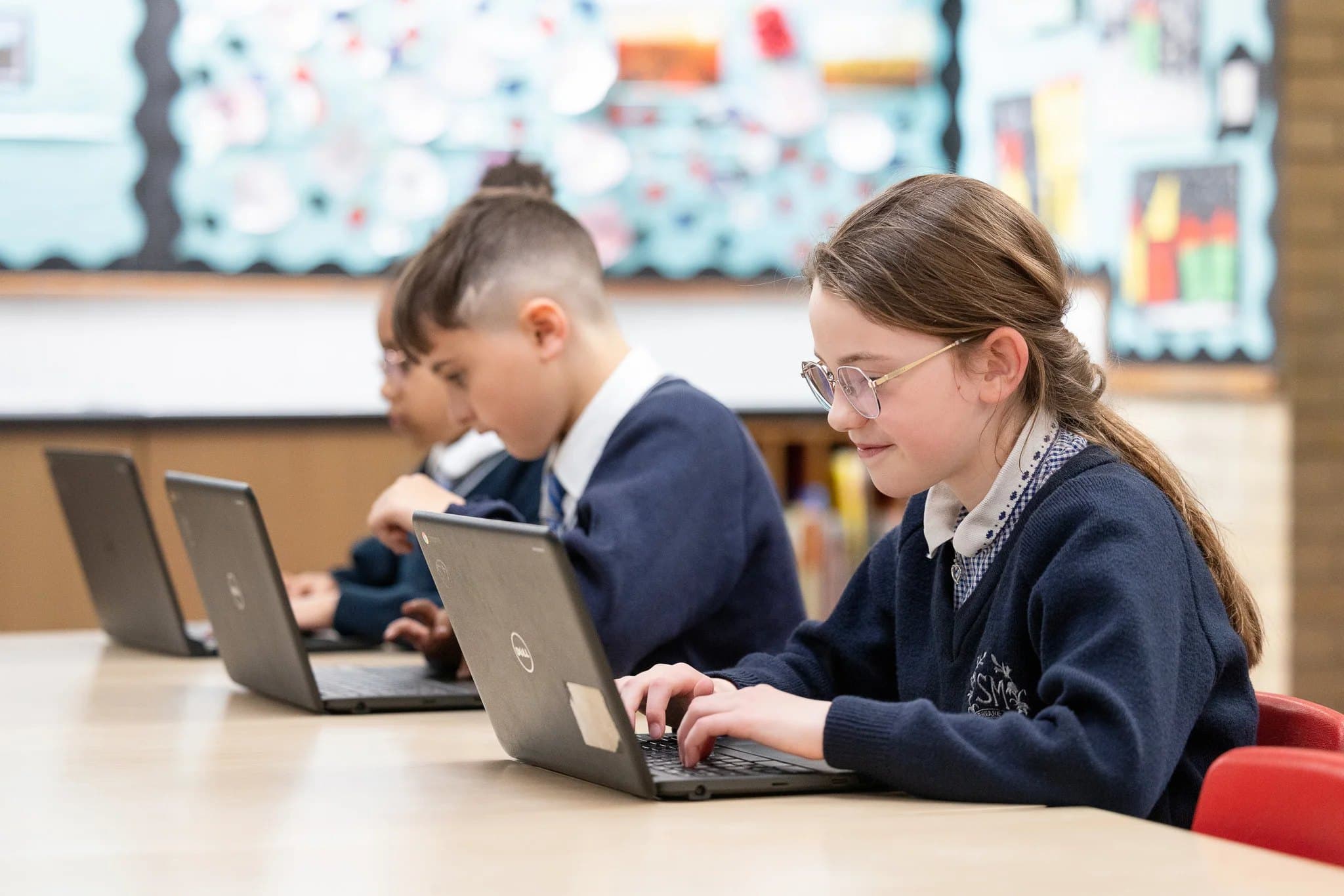 Older pupils working on laptops in class