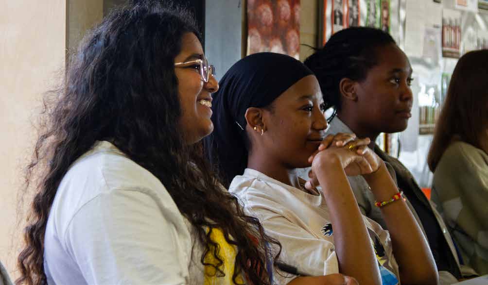 Sixth form students smiling during a group discussion